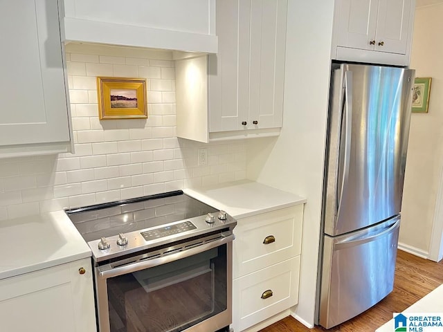 2713 Altadena Lake Rd, Birmingham, AL 35243 - kitchen with stainless steel appliances, decorative backsplash, white cabinetry, and light countertops