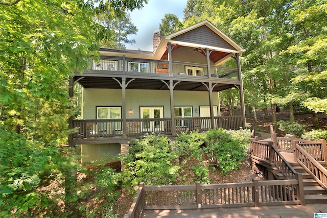 566 County Road 897, Wedowee, AL 36278 - rear view of house featuring a chimney, a balcony, a wooden deck, and stairs