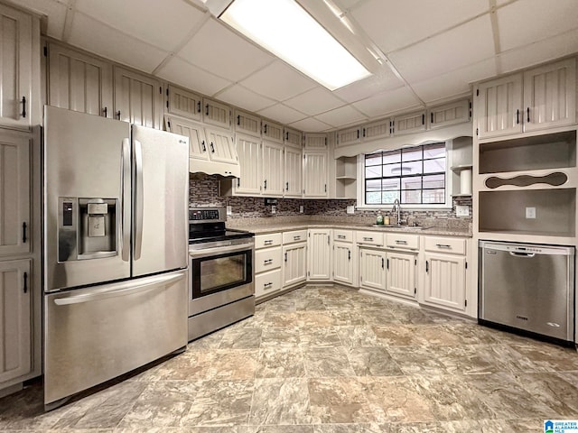 128 Carla Ave, Trussville, AL 35173 - kitchen featuring appliances with stainless steel finishes, open shelves, a paneled ceiling, and decorative backsplash