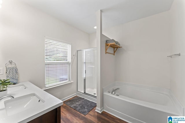 5633 Park Side Rd, Hoover, AL 35244 - bathroom featuring a bath, a shower stall, wood finished floors, and double vanity