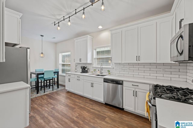 5633 Park Side Rd, Hoover, AL 35244 - kitchen with appliances with stainless steel finishes, white cabinetry, tasteful backsplash, dark wood-type flooring, and light countertops