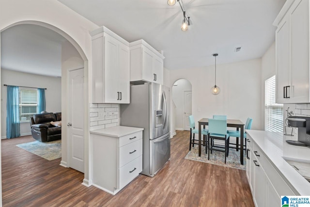 5633 Park Side Rd, Hoover, AL 35244 - kitchen with arched walkways, stainless steel fridge with ice dispenser, dark wood-style floors, and tasteful backsplash