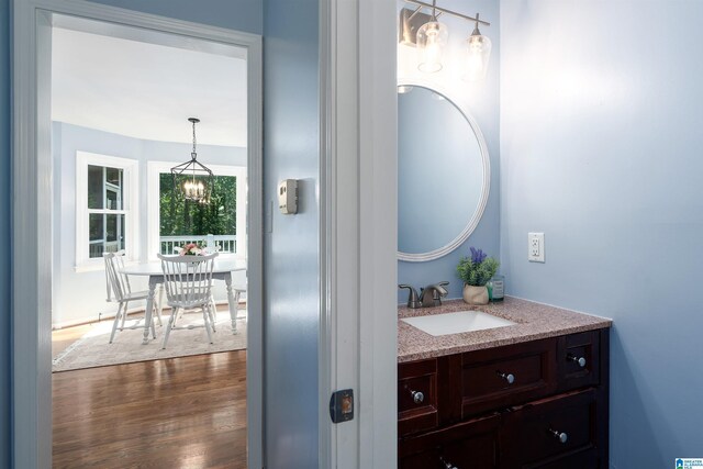 3624 Robin Cir, Birmingham, AL 35242 - bathroom with vanity, wood finished floors, and a chandelier