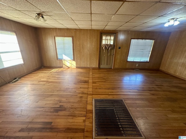 2910 Old Gadsden Hwy, Anniston, AL 36206 - unfurnished living room with hardwood / wood-style floors, a drop ceiling, and wood walls