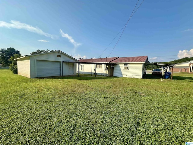 2910 Old Gadsden Hwy, Anniston, AL 36206 - back of house with a garage, a lawn, and a metal roof