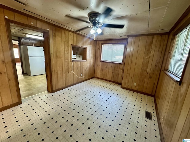 2910 Old Gadsden Hwy, Anniston, AL 36206 - spare room with wooden walls, ceiling fan, and light flooring