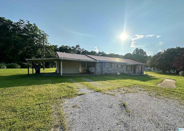 2910 Old Gadsden Hwy, Anniston, AL 36206 - view of home's exterior featuring a yard, a carport, a metal roof, and driveway