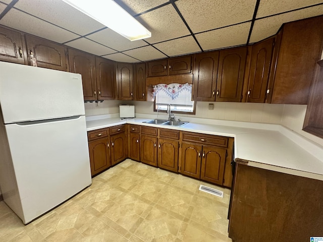 2910 Old Gadsden Hwy, Anniston, AL 36206 - kitchen featuring freestanding refrigerator, a drop ceiling, and light countertops