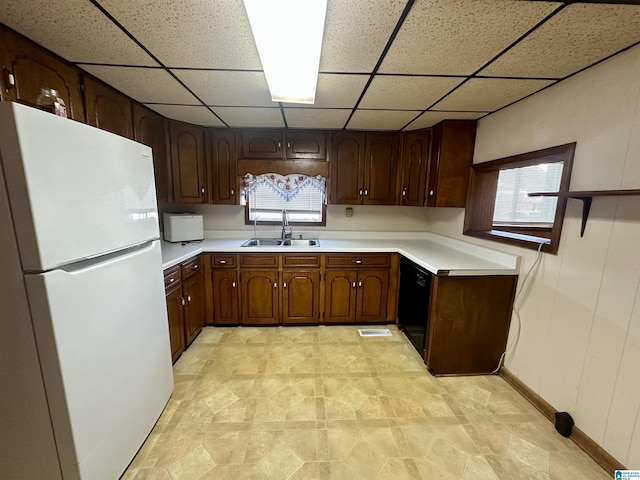 2910 Old Gadsden Hwy, Anniston, AL 36206 - kitchen with freestanding refrigerator, a drop ceiling, light countertops, healthy amount of natural light, and black dishwasher