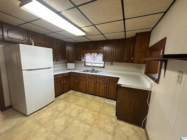 2910 Old Gadsden Hwy, Anniston, AL 36206 - kitchen with freestanding refrigerator, open shelves, a drop ceiling, dark brown cabinets, and light countertops
