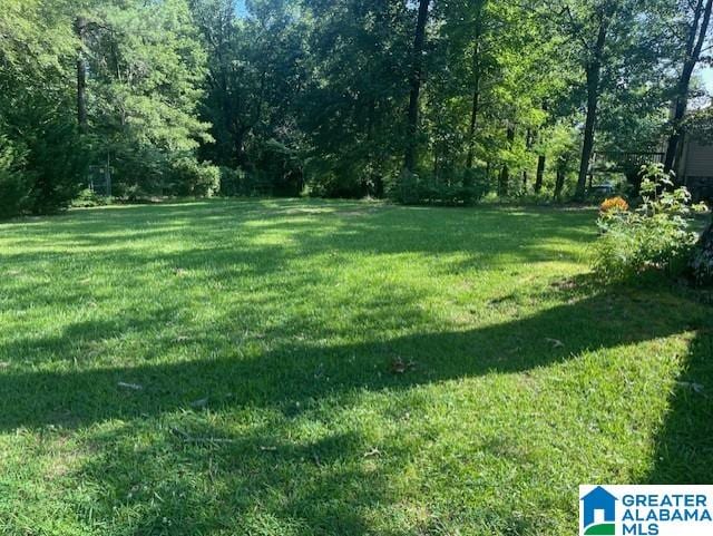 2215 Vicki Dr, Birmingham, AL 35235 - view of grassy yard with a view of trees