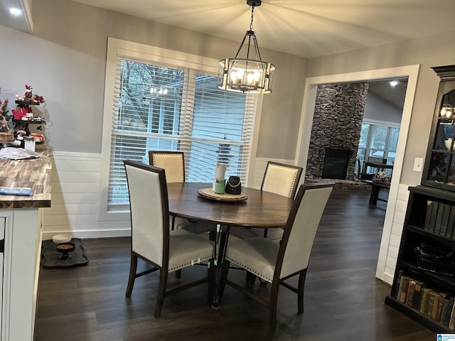 5404 Smith Rd, Pell City, AL 35128 - dining space with a fireplace, dark wood-style floors, a chandelier, and wainscoting