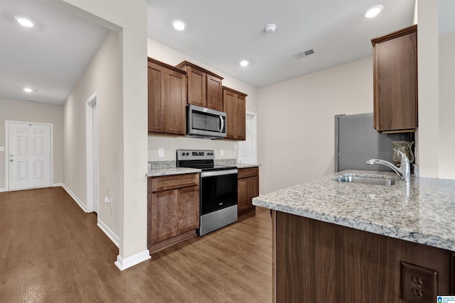 6370 Rainbow Row, Pell City, AL 35128 - kitchen featuring appliances with stainless steel finishes, wood finished floors, light stone counters, and recessed lighting