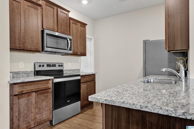 6370 Rainbow Row, Pell City, AL 35128 - kitchen featuring appliances with stainless steel finishes, light wood finished floors, light stone countertops, and recessed lighting
