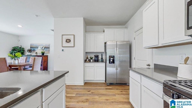 545 Sterling Pl, Odenville, AL 35120 - kitchen featuring stainless steel appliances, light wood-type flooring, white cabinets, dark countertops, and recessed lighting