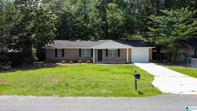 401 Ashley Dr, Pell City, AL 35125 - ranch-style home with brick siding, driveway, an attached garage, and a front lawn