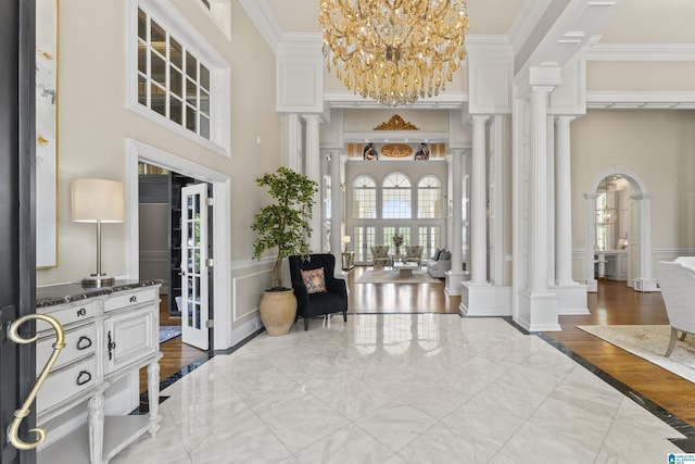 5615 Canongate Ln, Hoover, AL 35242 - entrance foyer with a decorative wall, decorative columns, a towering ceiling, ornamental molding, and a chandelier