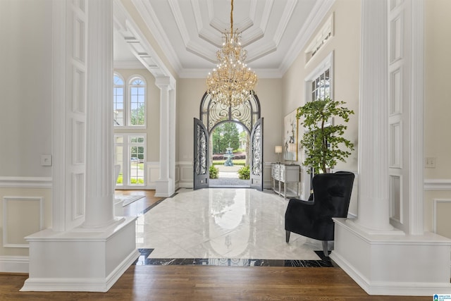 5615 Canongate Ln, Hoover, AL 35242 - foyer featuring ornate columns, a decorative wall, a chandelier, ornamental molding, and a high ceiling