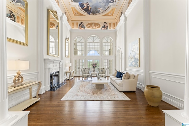 5615 Canongate Ln, Hoover, AL 35242 - living area with a decorative wall, a fireplace, crown molding, a high ceiling, and dark wood finished floors