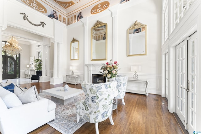 5615 Canongate Ln, Hoover, AL 35242 - living area featuring decorative columns, french doors, a decorative wall, a chandelier, and a high ceiling