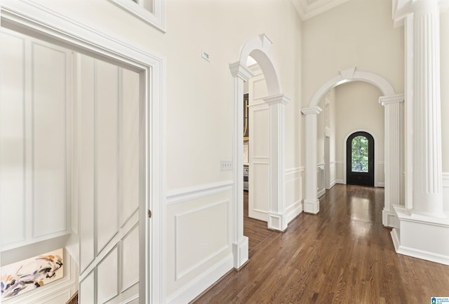 5615 Canongate Ln, Hoover, AL 35242 - corridor featuring decorative columns, arched walkways, a decorative wall, dark wood-type flooring, and wainscoting