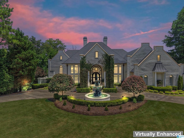 5615 Canongate Ln, Hoover, AL 35242 - french country home with curved driveway, a yard, and a chimney