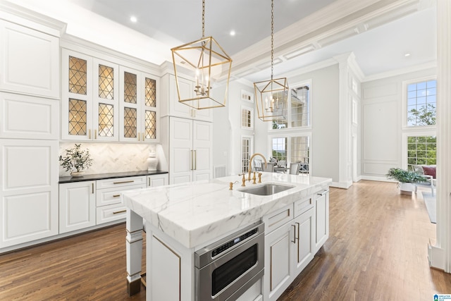 5615 Canongate Ln, Hoover, AL 35242 - kitchen featuring stainless steel microwave, a chandelier, healthy amount of natural light, pendant lighting, and crown molding