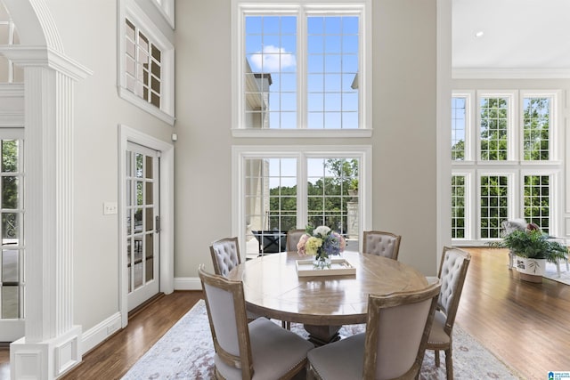 5615 Canongate Ln, Hoover, AL 35242 - dining area with healthy amount of natural light, dark wood-type flooring, a high ceiling, crown molding, and ornate columns