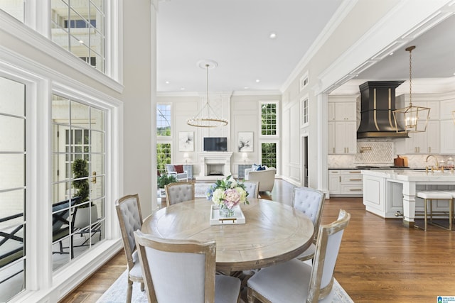 5615 Canongate Ln, Hoover, AL 35242 - dining area featuring a chandelier, a fireplace, dark wood-style flooring, ornamental molding, and recessed lighting