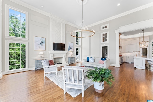 5615 Canongate Ln, Hoover, AL 35242 - living room with a chandelier, plenty of natural light, crown molding, a fireplace, and a decorative wall