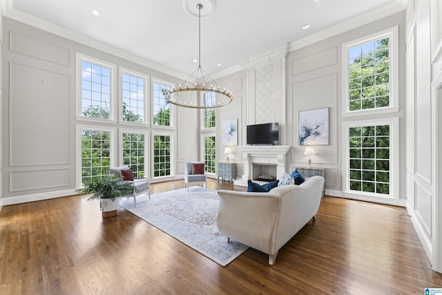 5615 Canongate Ln, Hoover, AL 35242 - living room featuring a decorative wall, a chandelier, healthy amount of natural light, a large fireplace, and a towering ceiling
