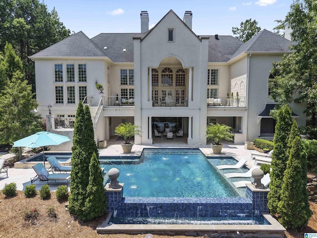 5615 Canongate Ln, Hoover, AL 35242 - rear view of house with stucco siding, a patio area, and a balcony
