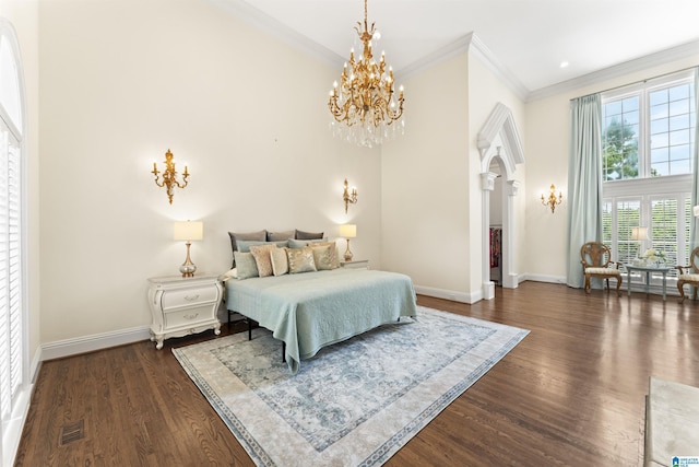 5615 Canongate Ln, Hoover, AL 35242 - bedroom featuring dark wood-style flooring, ornamental molding, arched walkways, and a chandelier