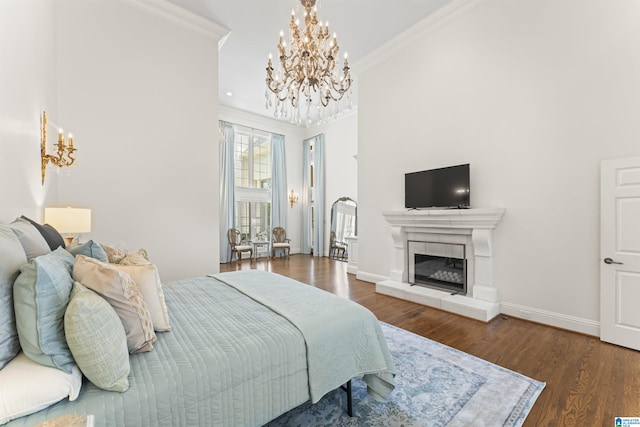 5615 Canongate Ln, Hoover, AL 35242 - bedroom featuring a chandelier, crown molding, wood finished floors, and a tile fireplace