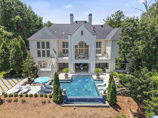 5615 Canongate Ln, Hoover, AL 35242 - rear view of property with stucco siding, a patio, stairway, an outdoor pool, and a chimney