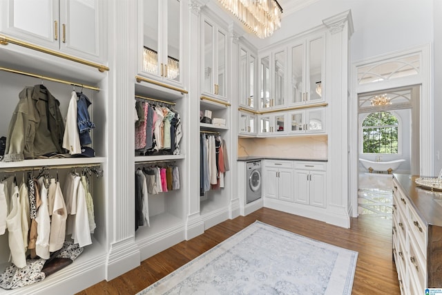 5615 Canongate Ln, Hoover, AL 35242 - walk in closet featuring washer / clothes dryer, wood finished floors, and a chandelier
