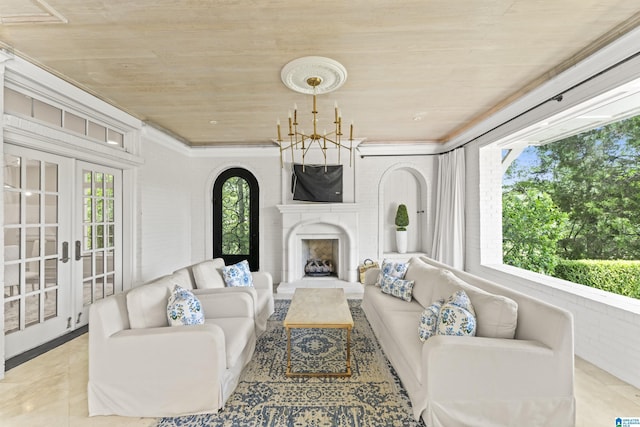 5615 Canongate Ln, Hoover, AL 35242 - tiled living room with wooden ceiling, a chandelier, a fireplace, french doors, and ornamental molding