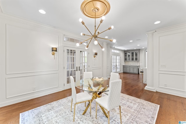 5615 Canongate Ln, Hoover, AL 35242 - dining area featuring french doors, a decorative wall, wood finished floors, a chandelier, and ornamental molding