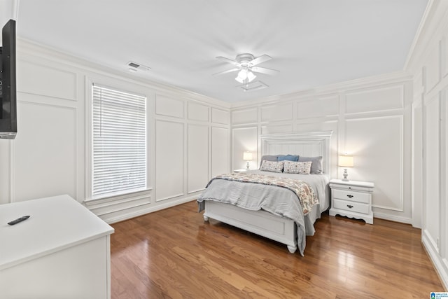 5615 Canongate Ln, Hoover, AL 35242 - bedroom with a decorative wall, a ceiling fan, wood finished floors, and ornamental molding