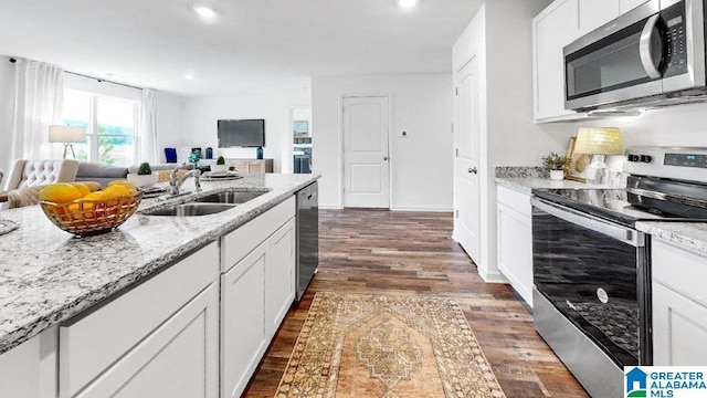 365 Koslin Loop, Calera, AL 35040 - kitchen with stainless steel appliances, open floor plan, dark wood-type flooring, white cabinetry, and recessed lighting
