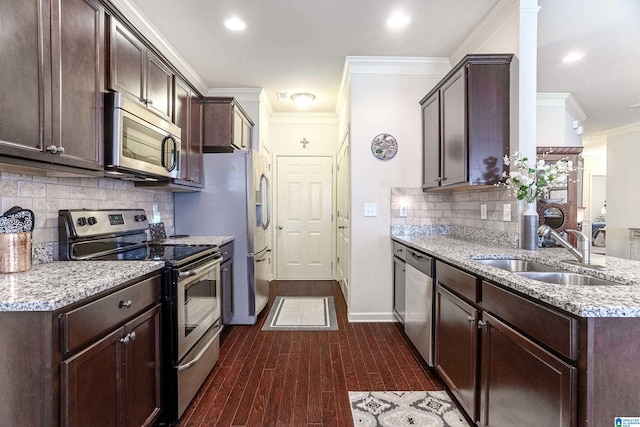 4955 Stonecreek Way, Calera, AL 35040 - kitchen with appliances with stainless steel finishes, dark brown cabinets, ornamental molding, dark wood finished floors, and tasteful backsplash