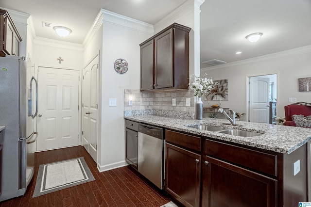 4955 Stonecreek Way, Calera, AL 35040 - kitchen featuring appliances with stainless steel finishes, light stone counters, dark wood finished floors, ornamental molding, and dark brown cabinetry