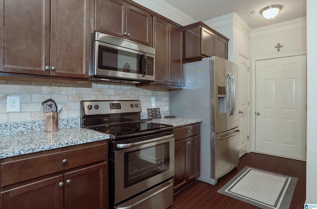 4955 Stonecreek Way, Calera, AL 35040 - kitchen with stainless steel appliances, crown molding, dark wood finished floors, light stone counters, and decorative backsplash