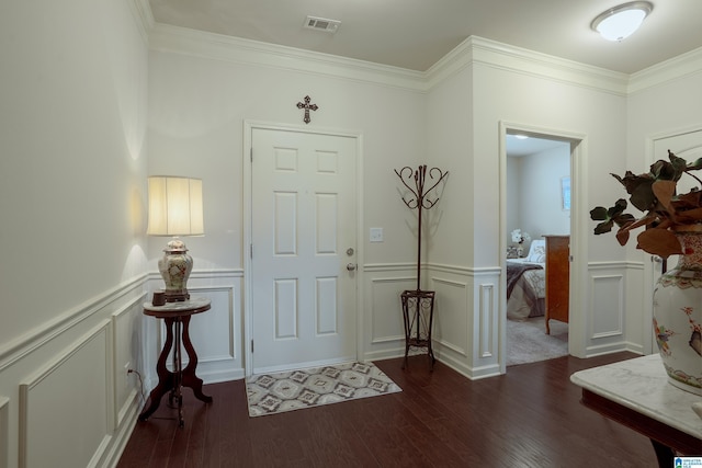 4955 Stonecreek Way, Calera, AL 35040 - entryway featuring dark wood-style floors, a wainscoted wall, ornamental molding, and a decorative wall