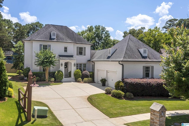 3688 Miller Hill Way, Vestavia Hills, AL 35243 - french country home with an attached garage, brick siding, a front lawn, and concrete driveway