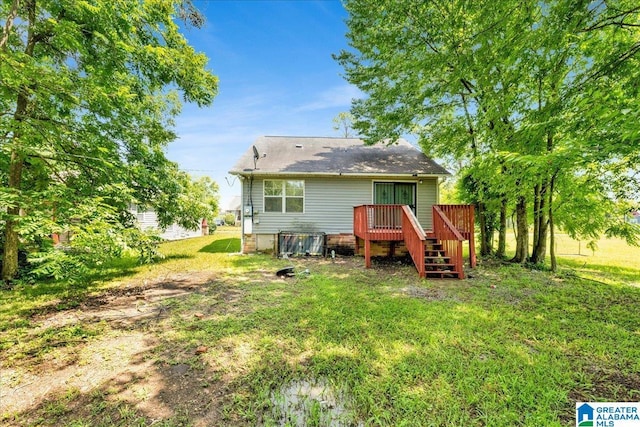 1324 Fulton Ave SW, Birmingham, AL 35211 - rear view of property featuring a wooden deck, stairs, and a lawn