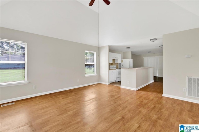 1324 Fulton Ave SW, Birmingham, AL 35211 - unfurnished living room with light wood-type flooring, ceiling fan, and high vaulted ceiling