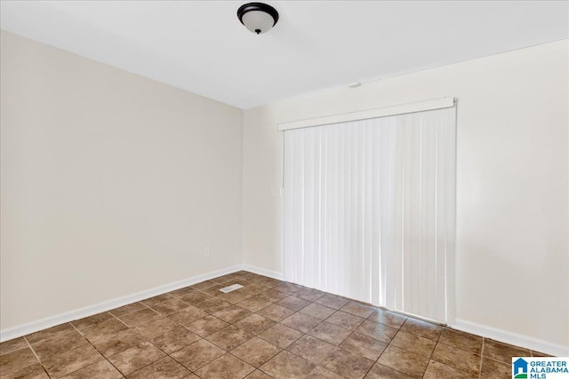 1324 Fulton Ave SW, Birmingham, AL 35211 - unfurnished room featuring baseboards and stone finish floors