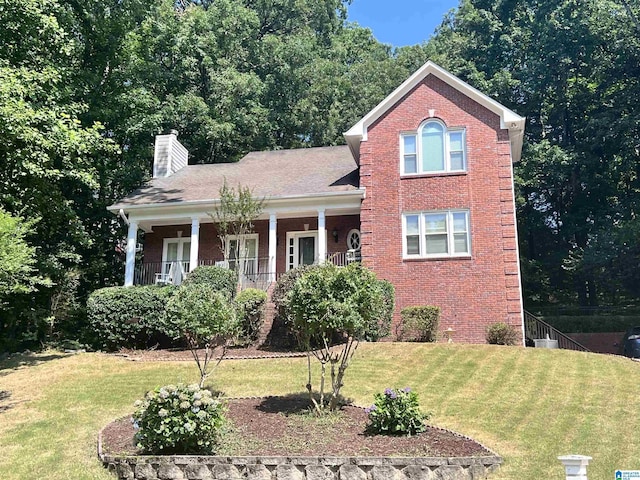 1813 Southpointe Cir, Hoover, AL 35244 - traditional-style house featuring brick siding, a chimney, a front yard, and a porch