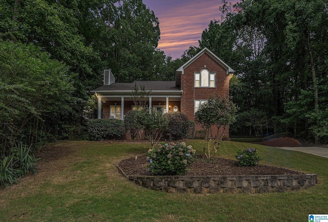 1813 Southpointe Cir, Hoover, AL 35244 - traditional-style house featuring a chimney, a front lawn, brick siding, and a porch